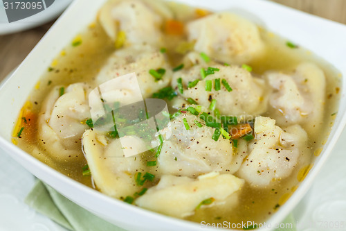 Image of Dish of savory pork tortellini in broth pelmeni russian