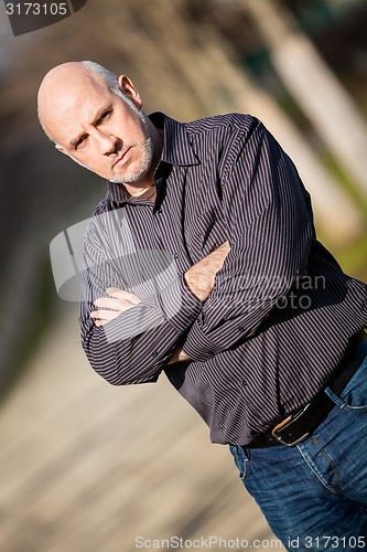 Image of Confident attractive man standing waiting