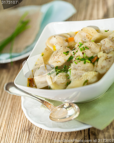 Image of Dish of savory pork tortellini in broth pelmeni russian