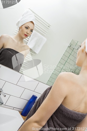 Image of Woman From Shower Looking her Face at the Mirror