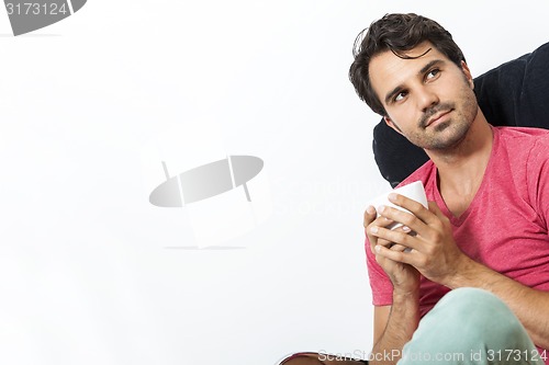 Image of Man Sitting on Chair with Book and a Drink