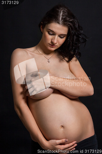 Image of Pregnant woman posing nude