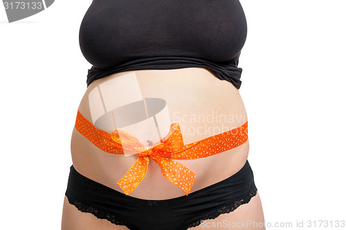 Image of Pregnant woman wearing a bow on her belly