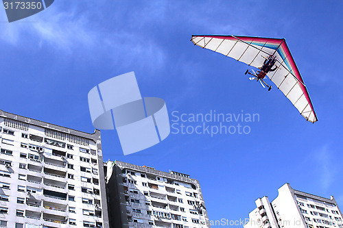 Image of Hang glider over buildings