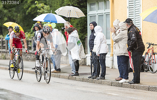 Image of Two Cyclists Riding in the Rain