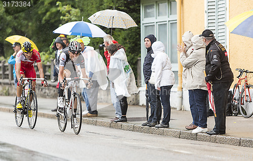 Image of Two Cyclists Riding in the Rain