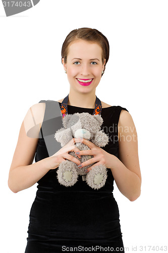 Image of attractive smiling brunette holding teddy bear