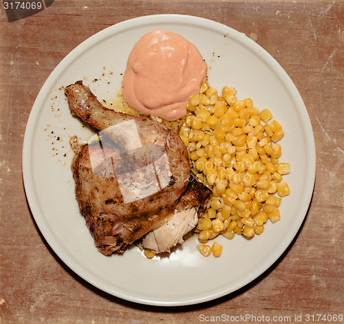 Image of grilled chicken with corn and hot sauce