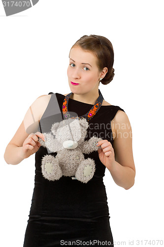 Image of attractive smiling brunette holding teddy bear