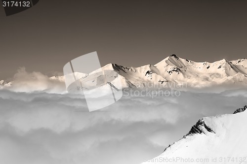 Image of Vintage winter mountains under clouds