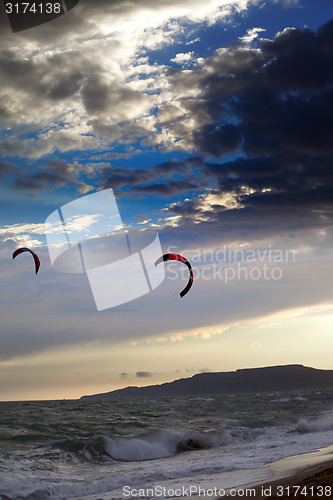 Image of Two silhouette of power kites at sunset sky