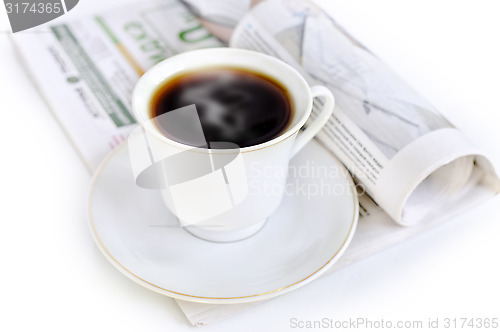 Image of A cup of hot coffee and newspaper 