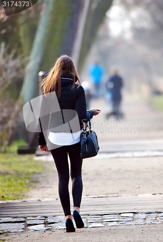 Image of young woman in spring in park