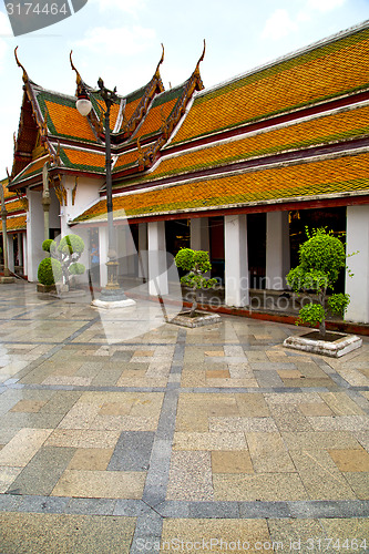 Image of gold    temple   in   bangkok plant pavement