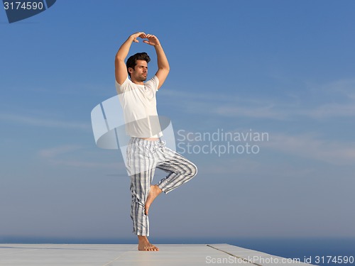 Image of young man practicing yoga