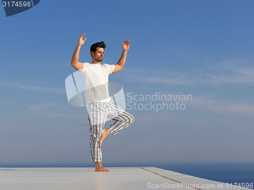 Image of young man practicing yoga