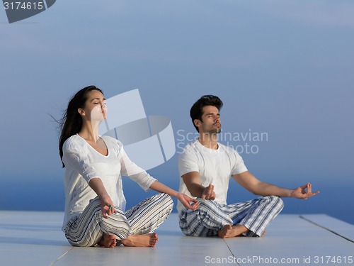 Image of young couple practicing yoga