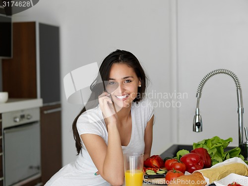 Image of Young Woman Cooking in the kitchen