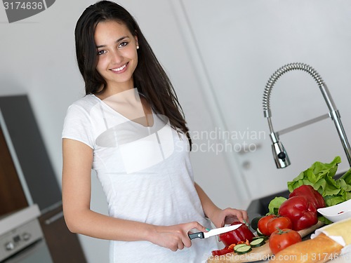 Image of Young Woman Cooking in the kitchen