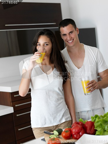 Image of happy young couple in kicthen