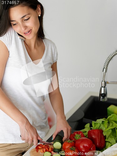 Image of Young Woman Cooking in the kitchen