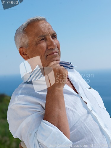 Image of senior man sitting outside