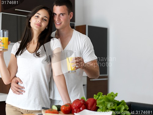 Image of happy young couple in kicthen