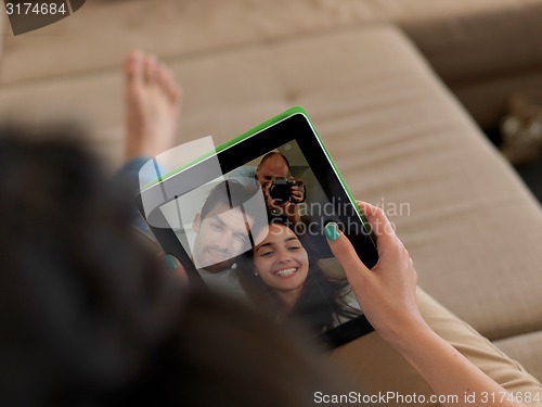 Image of young couple making selfie together at home