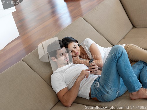 Image of young couple making selfie together at home