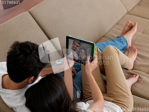 Image of young couple making selfie together at home