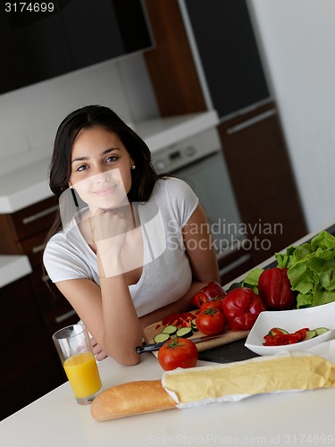 Image of Young Woman Cooking in the kitchen