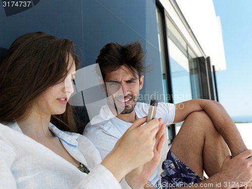 Image of young couple making selfie together at home