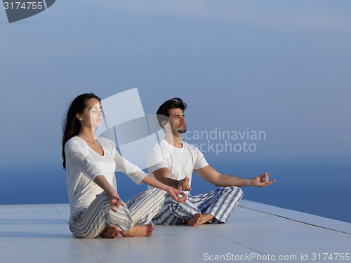 Image of young couple practicing yoga