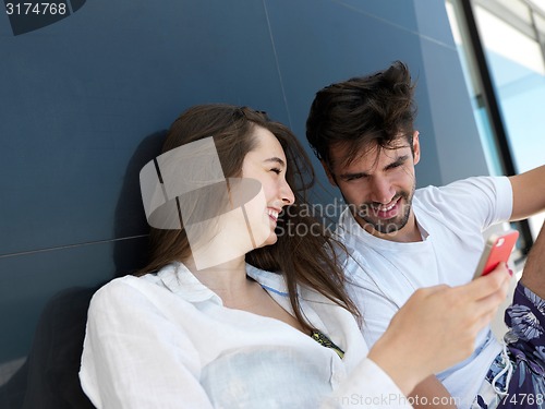 Image of young couple making selfie together at home