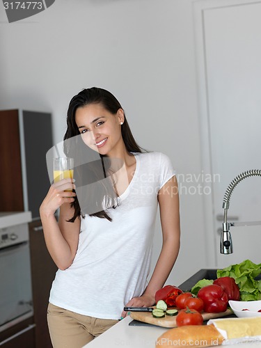 Image of Young Woman Cooking in the kitchen
