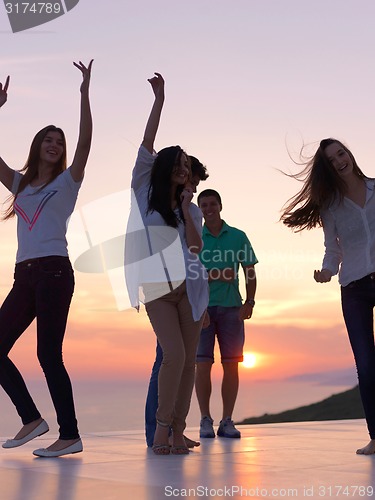 Image of party people  on sunset