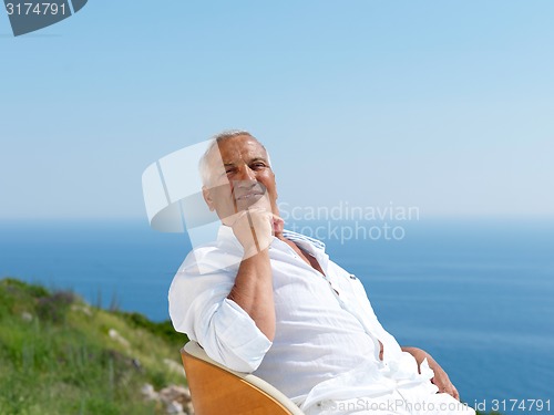 Image of senior man sitting outside