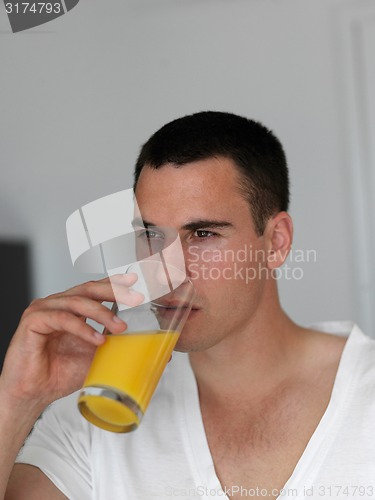 Image of man having orange juice
