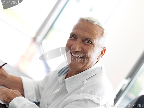 Image of Portrait of senior man relaxing in sofa