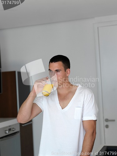 Image of man having orange juice