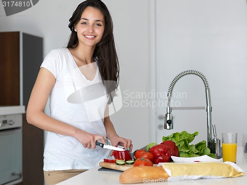 Image of Young Woman Cooking in the kitchen