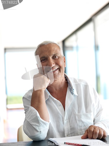 Image of Portrait of senior man relaxing in sofa