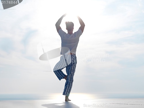 Image of young man practicing yoga