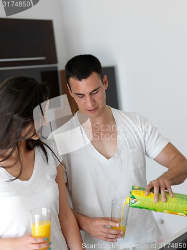 Image of happy young couple in kicthen