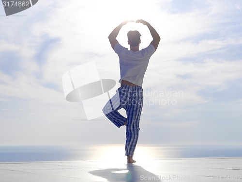 Image of young man practicing yoga