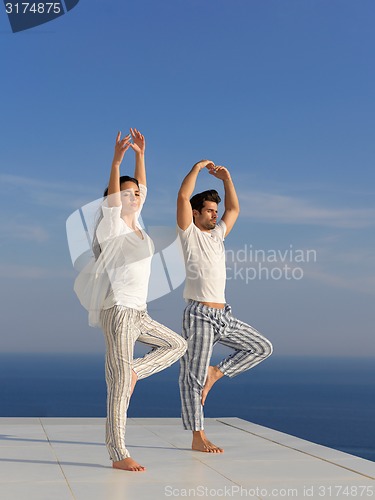 Image of young couple practicing yoga