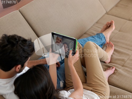 Image of young couple making selfie together at home