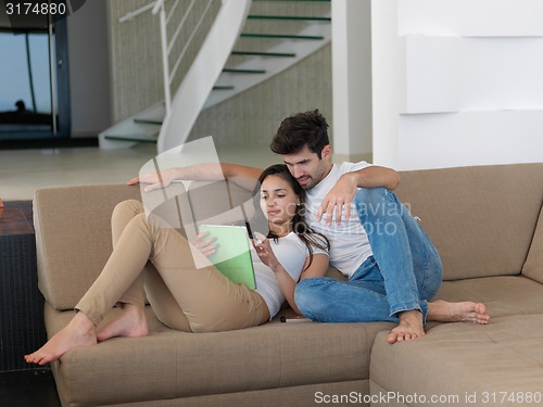 Image of young couple making selfie together at home