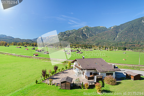 Image of Alpine mountains summer green meadow in valley landscape