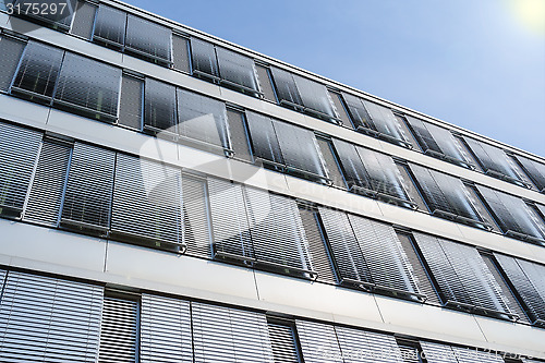 Image of High-rise office building facade with covered windows Venetian b